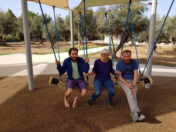 Silver with her sons on a swing.